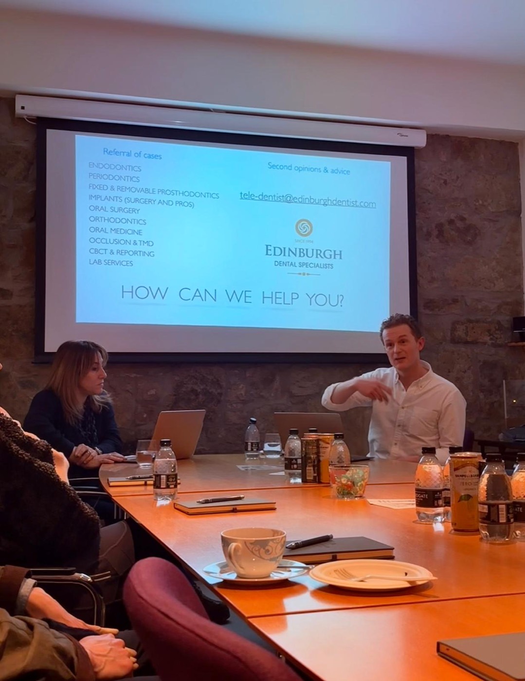Chris teaching at a study session, in front of a slide reading How can we help you?